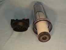 Standard #10 water filter housing with Doulton ceramic water filter laying beside